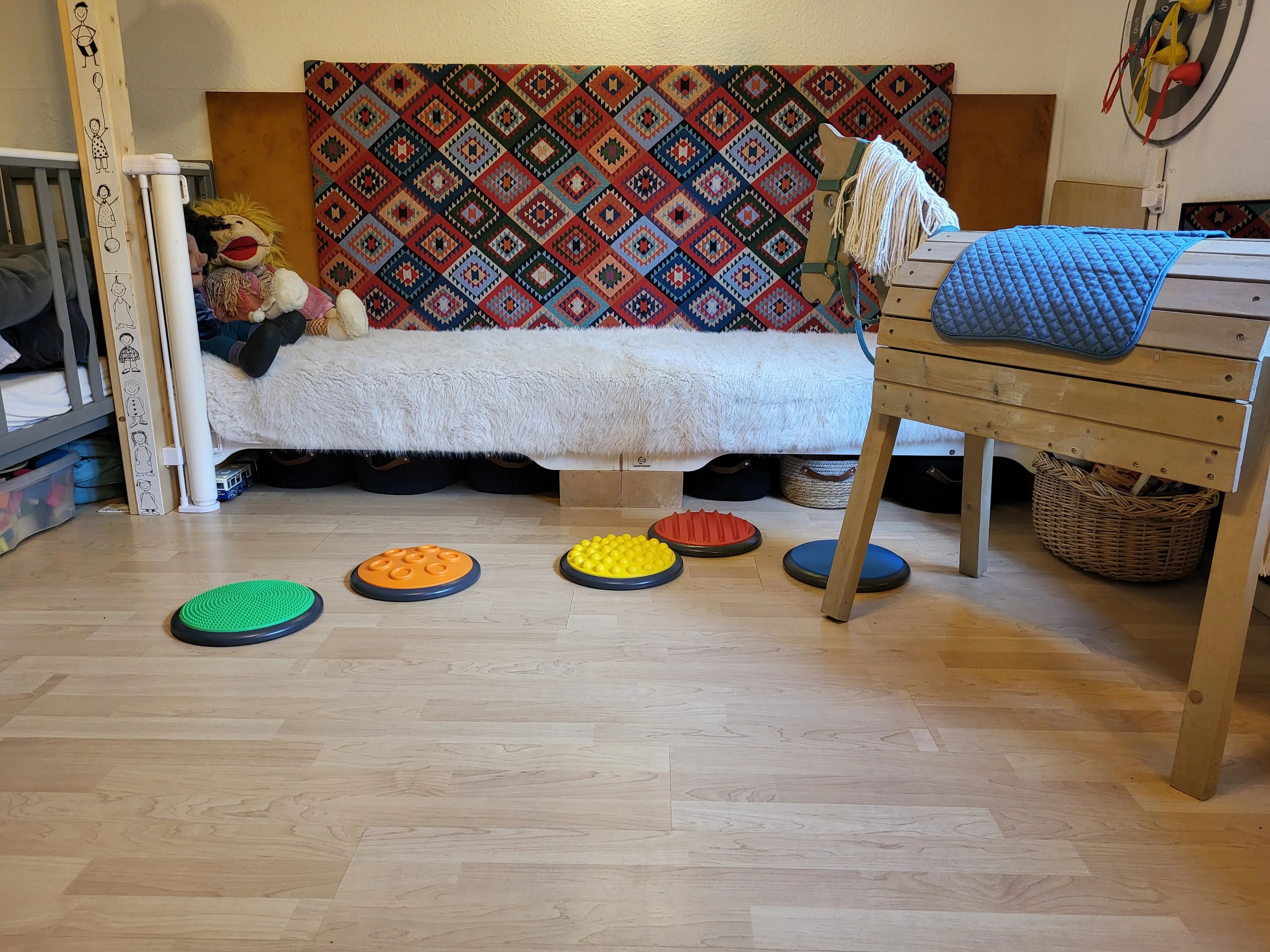 Gemütliches Spielzimmer mit Steckenpferd, Sinnes-Balance-Pads und Kuscheltieren